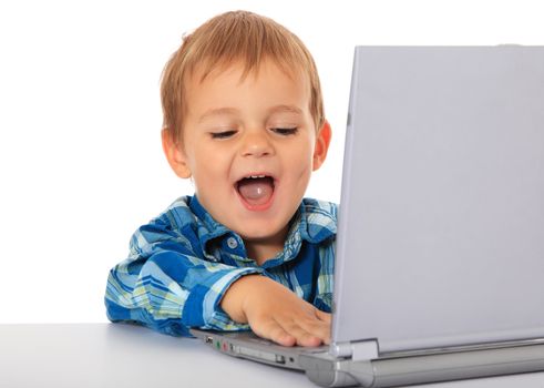 Cute caucasian boy using laptop. All on white background.