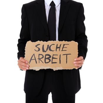 Businessman holding cardboard sign with the german term "suche arbeit" (Engl.: hunting for a job). All on white background.