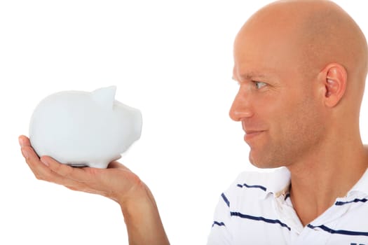 Attractive middle age man looking at piggy bank. All on white background.