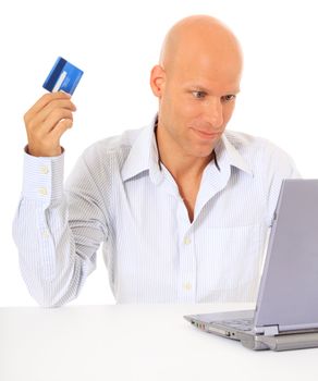 Attractive middle age man ordering things on the internet. All on white background.