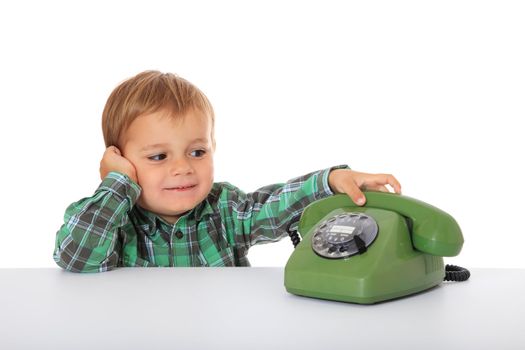 Cute caucasian boy using telephone. All on white background.