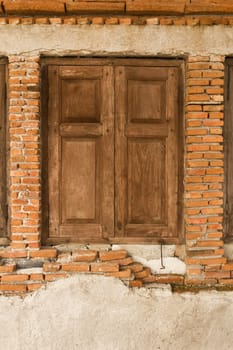 Old wooden window on old brick wall