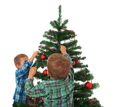 Two cute caucasian boys decorating the christmas tree. All on white background.