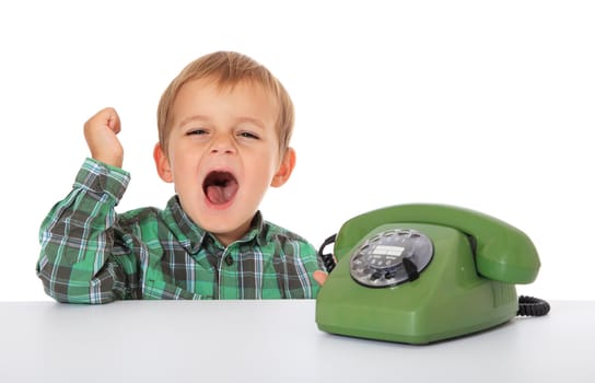 Cute caucasian boy using telephone. All on white background.