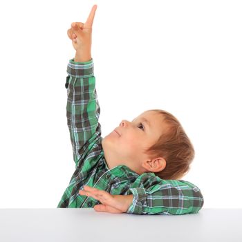 Cute caucasian boy points with finger. All on white background.