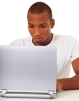 Attractive black guy using laptop. All on white background.