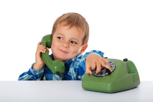 Cute caucasian boy using telephone. All on white background.