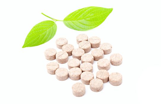 Pills with green leaf isolated on a white background. Herbal Medicine. 