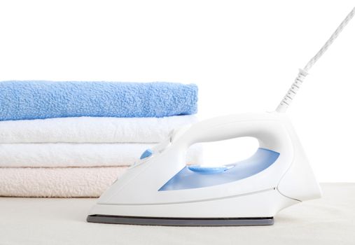 electric iron and towels, on white background 