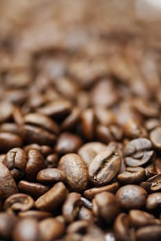 Pile of decaffinated coffee beans, short DOF focus on foreground.
