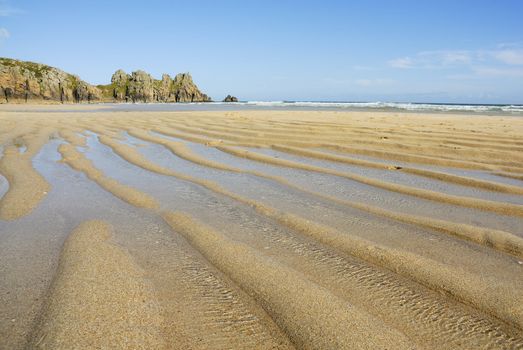 Pedn vounder beach, one of Cornwall's best beaches with stunning cliffs of Treryn Dinas, crystal clear water and a beautiful sandy beach.
 
 On a spring low tide one can walk to Pedn Vounder from neighbouring Porthcurno beach but be warned, as the tide comes in you will not only find yourself cut off but facing a climb up the steep cliff "path"
 
 The headland to the east of the beach is the location of the famous Logan Rock, a rectangular block of granite which weighs about 70 tons, and which can be rocked back and forth by one person.
 
 Pedn Vounder is an unoffical naturist beach