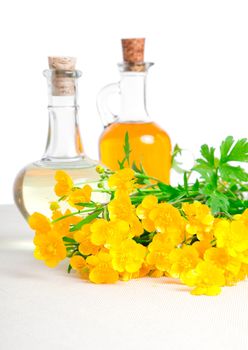 bottle of oil with rapeseed flower, on a canvas background 