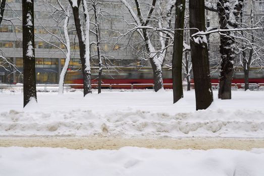 Blurred tram in the background of a wintery scene in Poland.