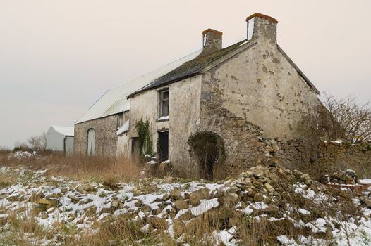 Derict farm building in South Wales, UK. Snow on ground.