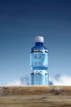 water in cup mountains on background