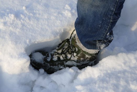 Mans boot making a footprint in deep snow, Warsaw, Poland.