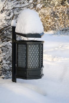 Heavy snow piled on a bin in Lazienkowski park, Warsaw, Poland.