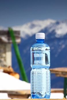 water in cup mountains on background