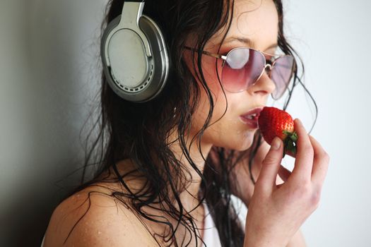 happy woman dance in phones and eat strawberry