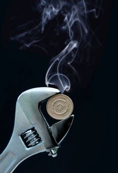Smoke rising from a coin being squeezed by pliers 