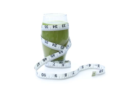Nutritious green smoothie with a measuring tape