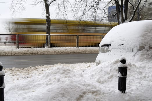 Blurred tram in the background of a wintery scene in Warsaw,  Poland.