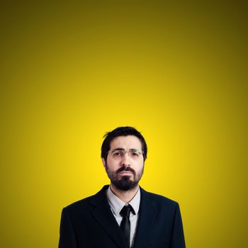 sad businessman on yellow background