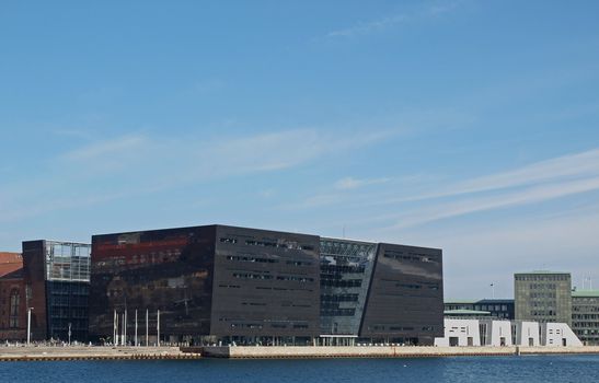 COPENHAGEN - MAR 16: The Royal Library of Copenhagen, Denmark (The Black Diamond) seen from a canal sight-seeing tour at the inner harbour of Copenhagen, Denmark on March 16, 2013.