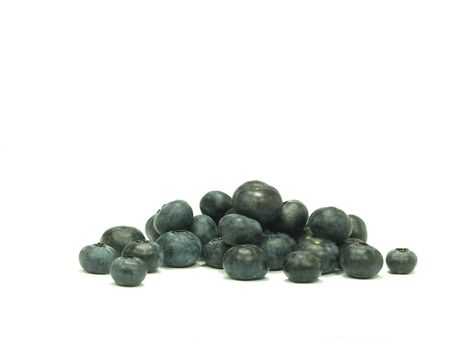 pile of ripe blue berries on white background     