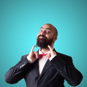 funny bearded elegant man with papillon on blue background