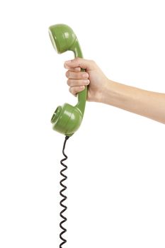 Female hand holding a green handpiece from a vintage telephone