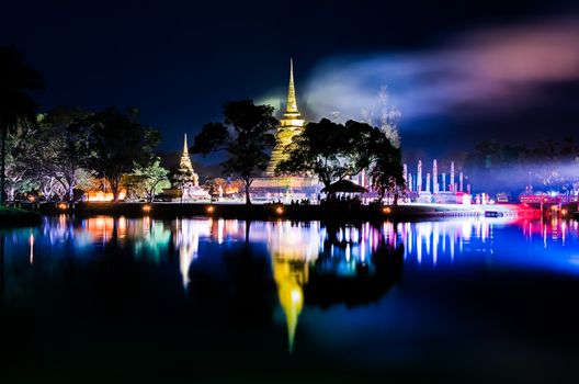 Buddhist colorful temple Wat Sa Si at night with lake reflection, Sukhothai, Thailand