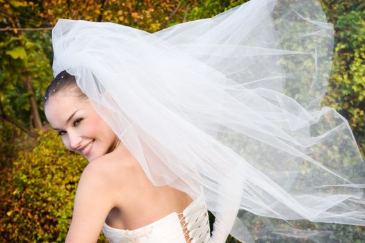 a smiling beautiful bride with fly veil