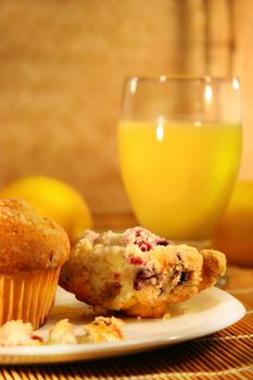 Healthy breakfast with cranberry muffins and orange juice on bamboo mat