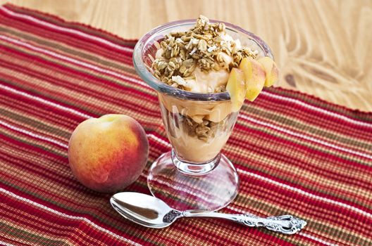 Delicious parfait with peaches, granola and yogurt.