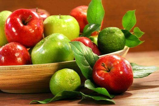 Red and green apples in a wooden bowl