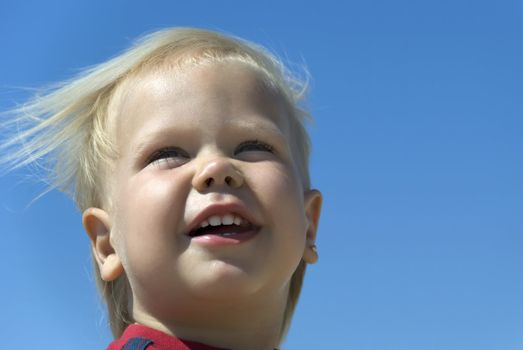 laughing the boy. The two-year-old blue-eyed blonde.