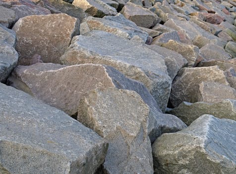 a close up image of breakwater boulders