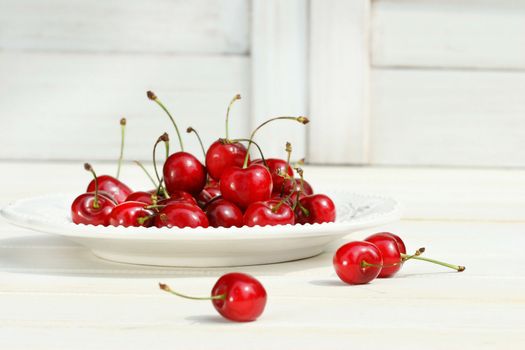 Cherries on a wite plate with white background