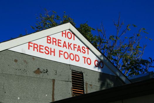 Restaurant sign on top of a restaurant.
