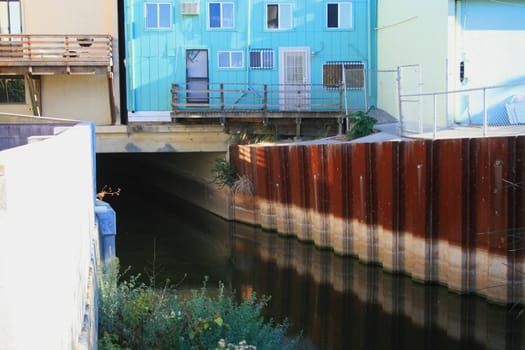 River canal under the buildings of a city.
