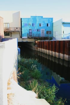 River canal under the buildings of a city.
