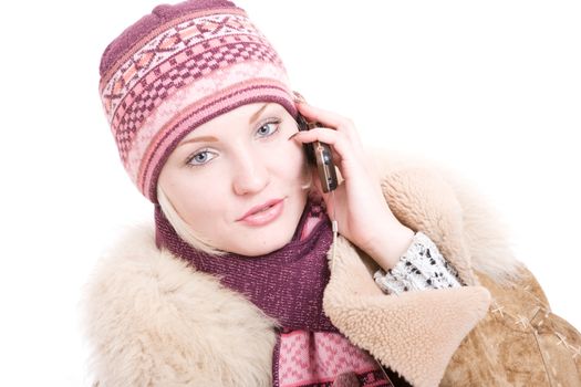 serious young Woman dressed in winter clothes talking a mobile phone