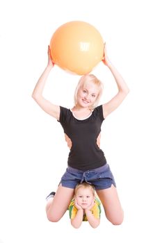 smiling happy young mother and her little son with a fitness ball on the floor