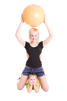 smiling happy young mother and her son with a fitness ball on the floor