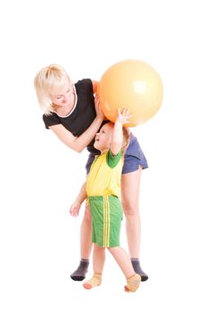 mother and her son looking one to another with a fitness ball in their hands