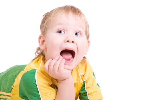 a shouting boy lays on the floor with the open mouth