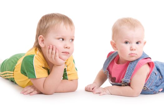 a boy of three years and a girl of one and a half laying on the floor