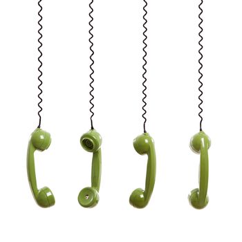 Handset piece from an old phone suspended by the phone cord, isolated on white background