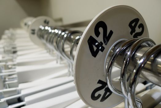 Row of clothes hangers with body size mark